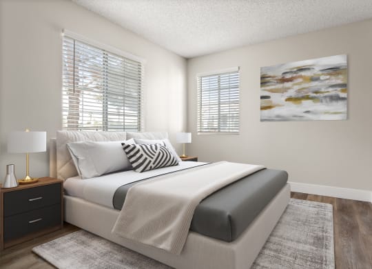a bedroom with a bed and two windows